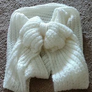 A white scarf that has a bow in the middle